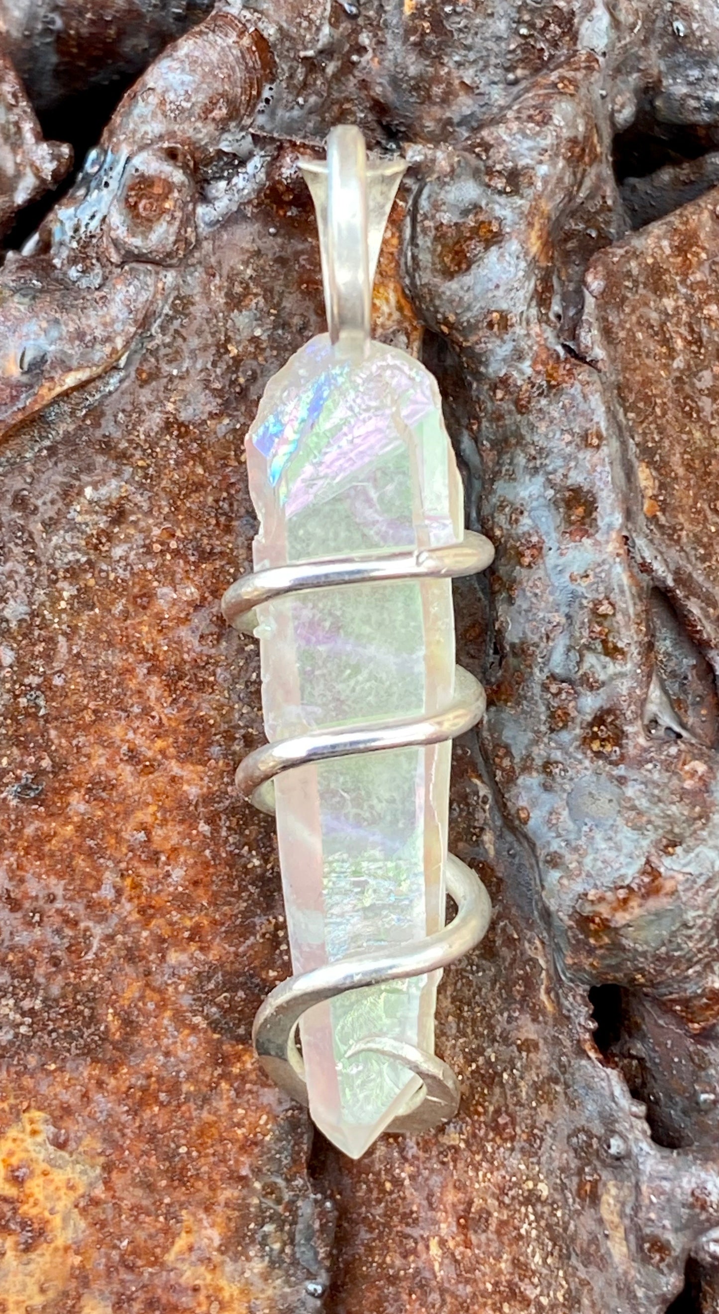 Platinum Infused Quartz Crystal in Sterling Silver Tension Wrapped Pendant